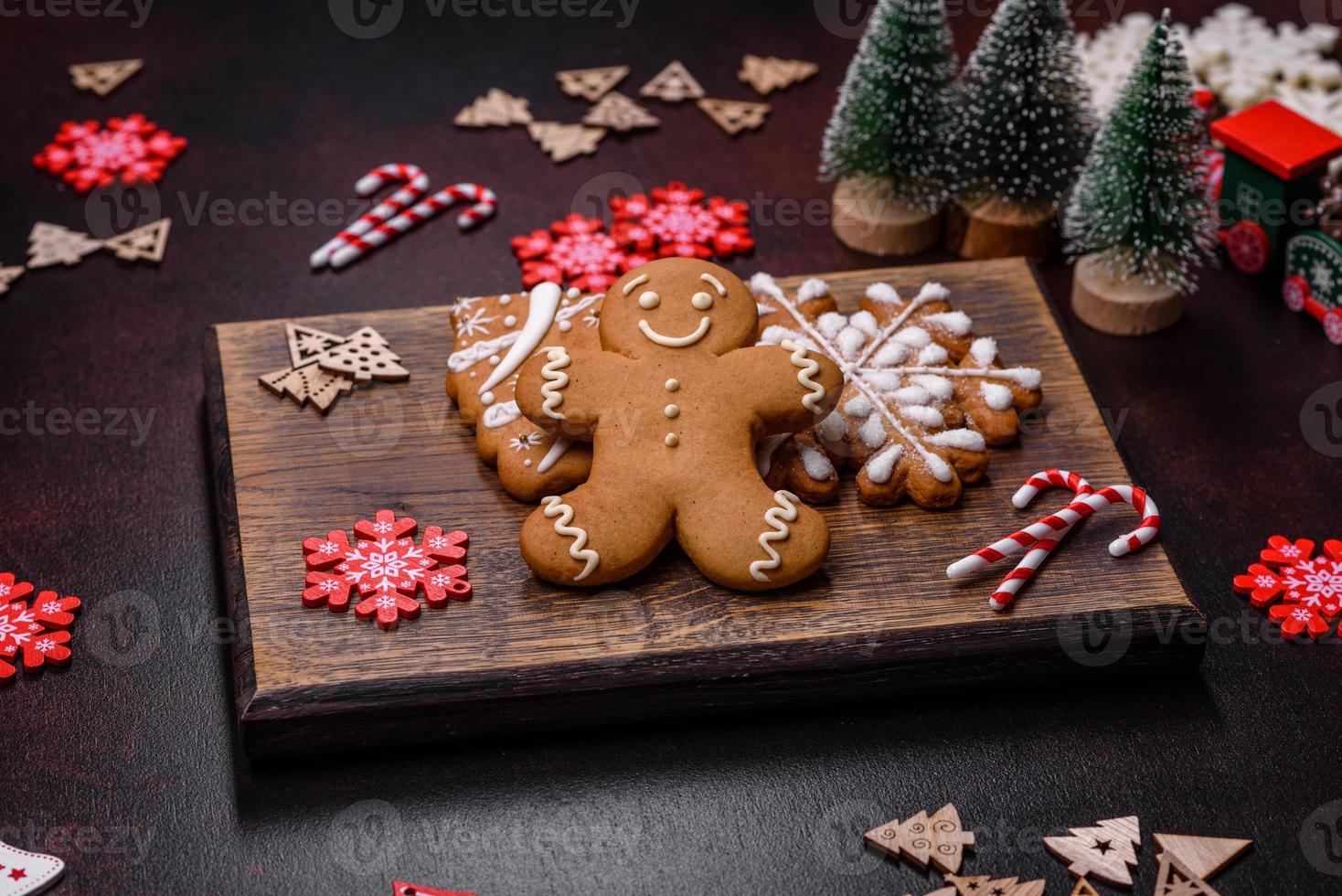 Christmas decoration elements as well as gingerbread on a brown concrete background photo