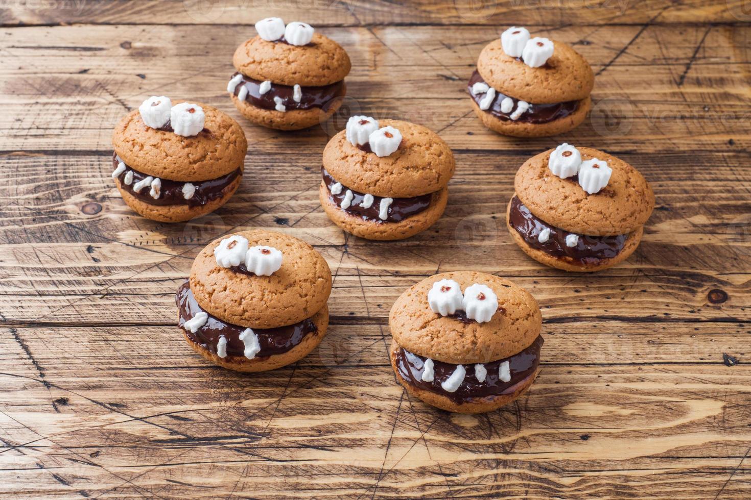 Cookies with chocolate paste in the form of monsters for Halloween photo