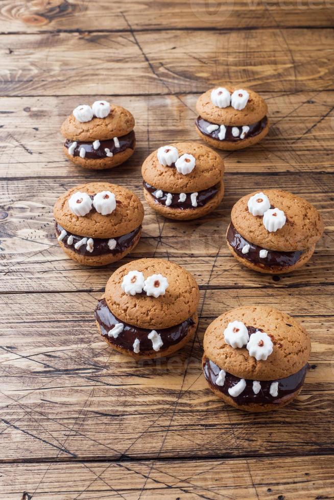 Cookies with chocolate paste in the form of monsters for Halloween photo