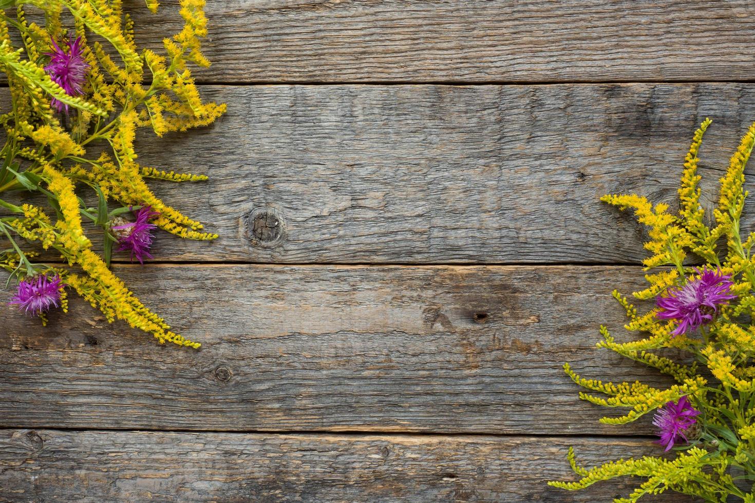 Autumn flowers on wooden rustic background. Copy space photo