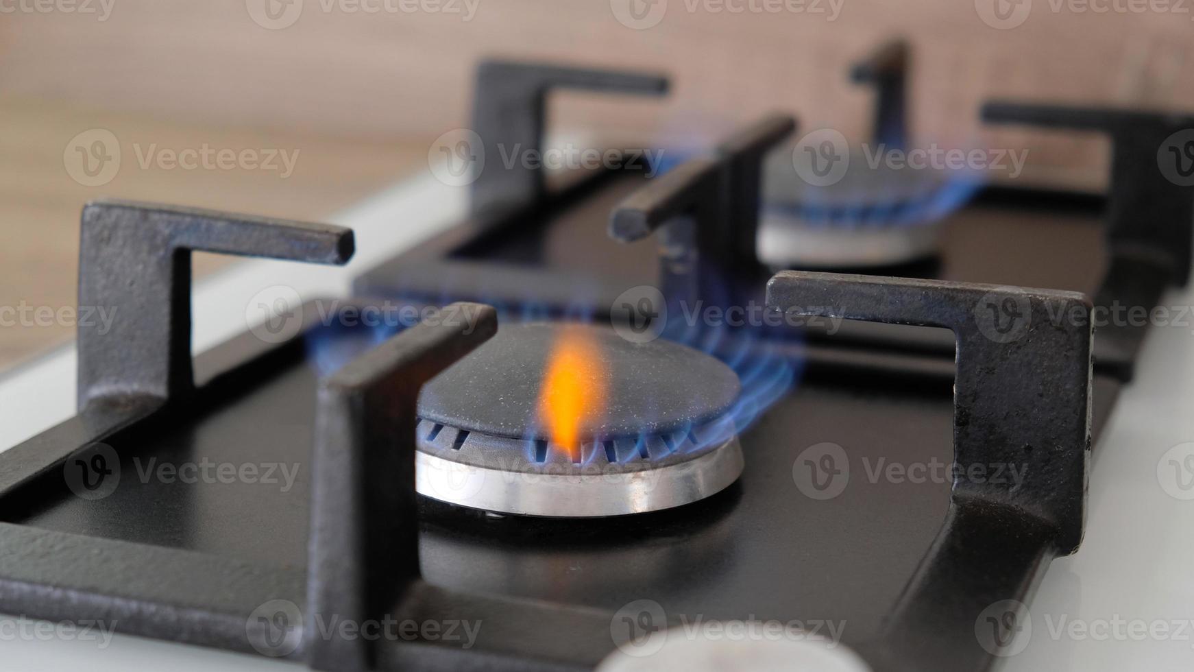 Close-up blue flames of fire on a gas burner in the kitchen for cooking. Gas flame in a gas boiler photo