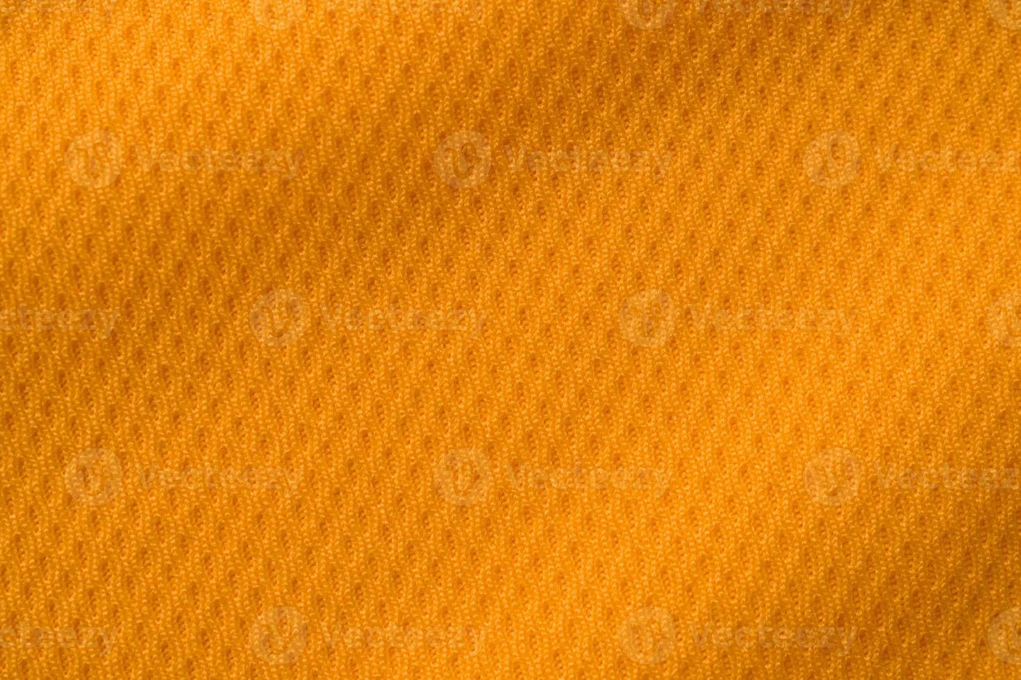 vista superior de textura de camiseta de fútbol de jersey de tela de ropa deportiva de color naranja foto