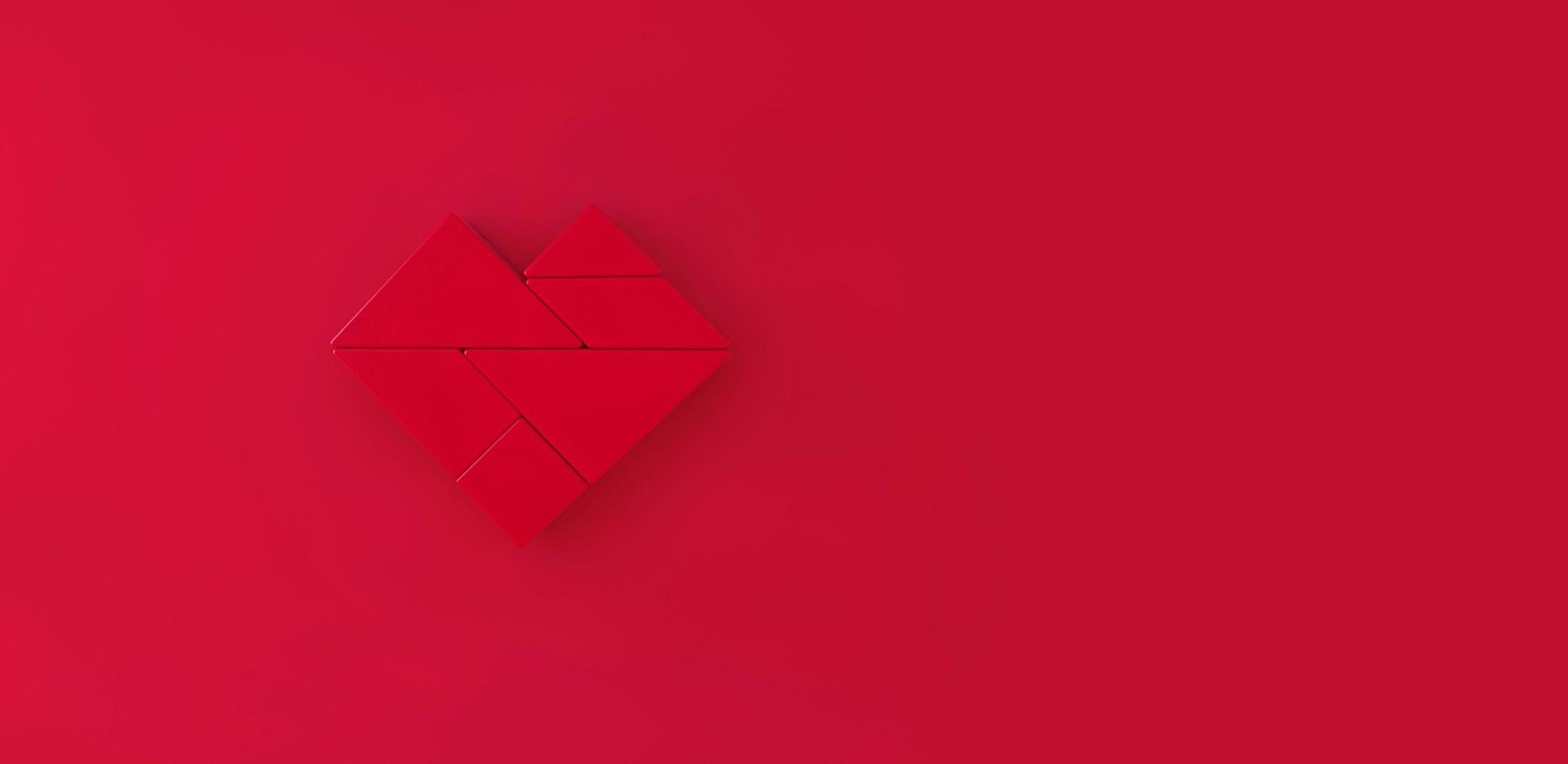 Red Heart tangram on red background. photo