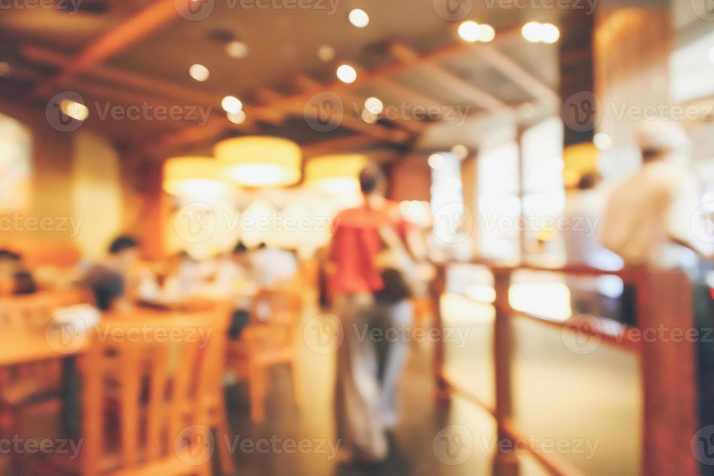 Restaurant interior with customer and wood table blur abstract background with bokeh light photo