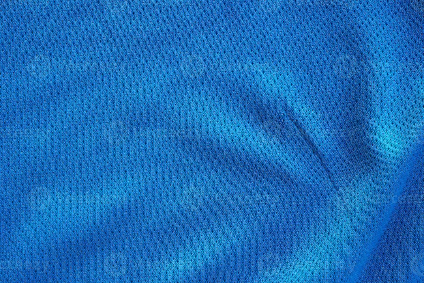 Blue fabric sport clothing football jersey with air mesh texture background photo