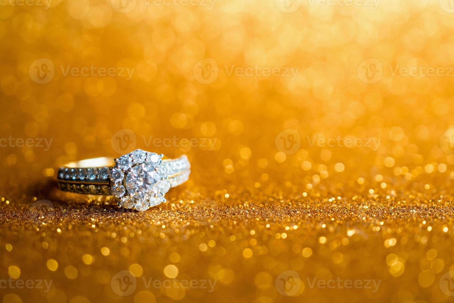 Jewelry diamond ring with abstract festive glitter Christmas holiday texture background blur with bokeh light photo