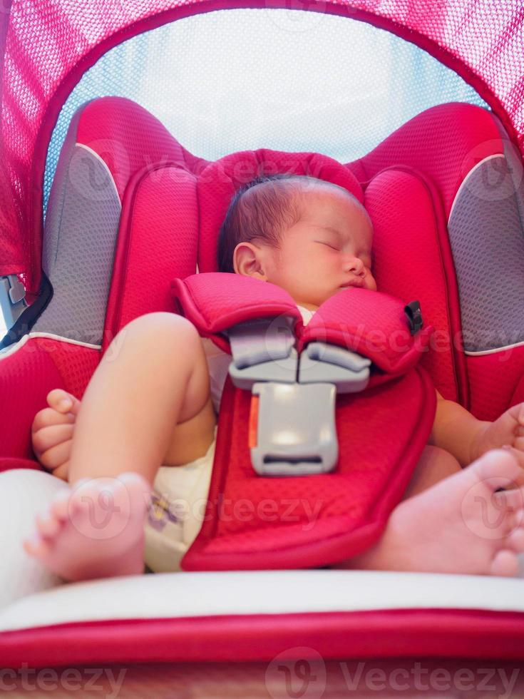 newborn baby sit in the car seat for safety photo