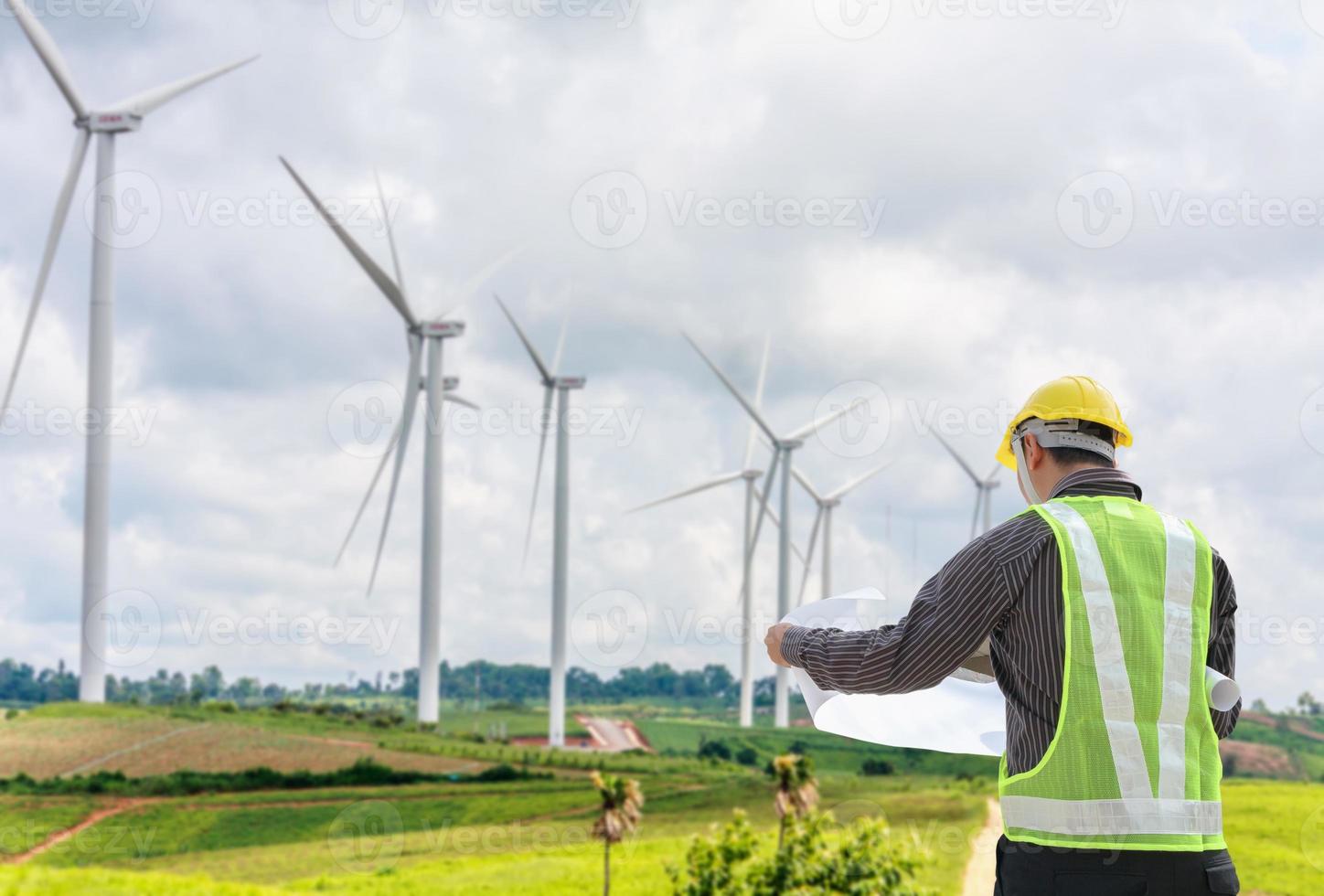 Engineer worker at wind turbine power station construction site photo