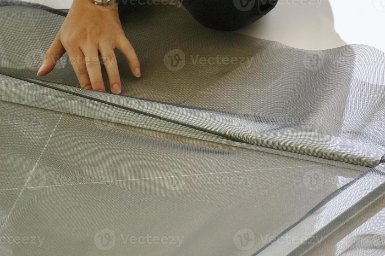 man install mosquito net wire screen on house window protection against insect photo