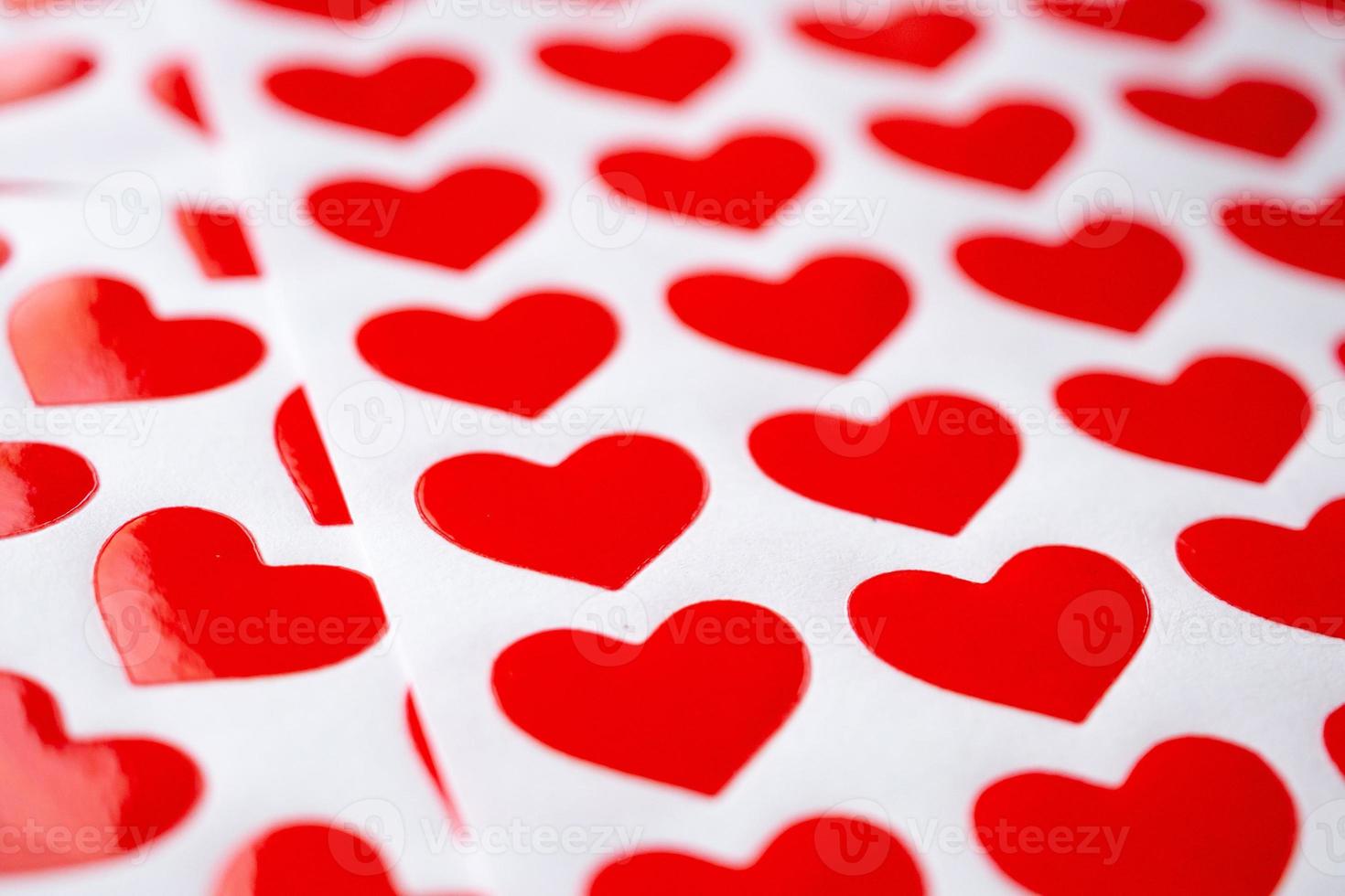 Close up red heart sticker on white paper photo