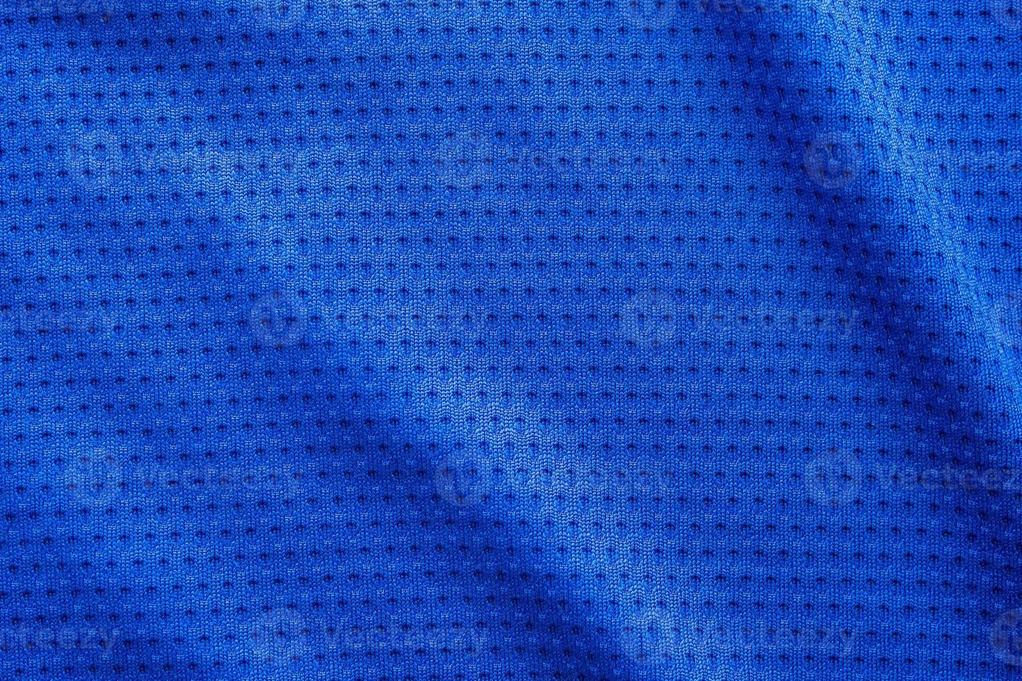 Blue color fabric sport clothing football jersey with air mesh texture background photo