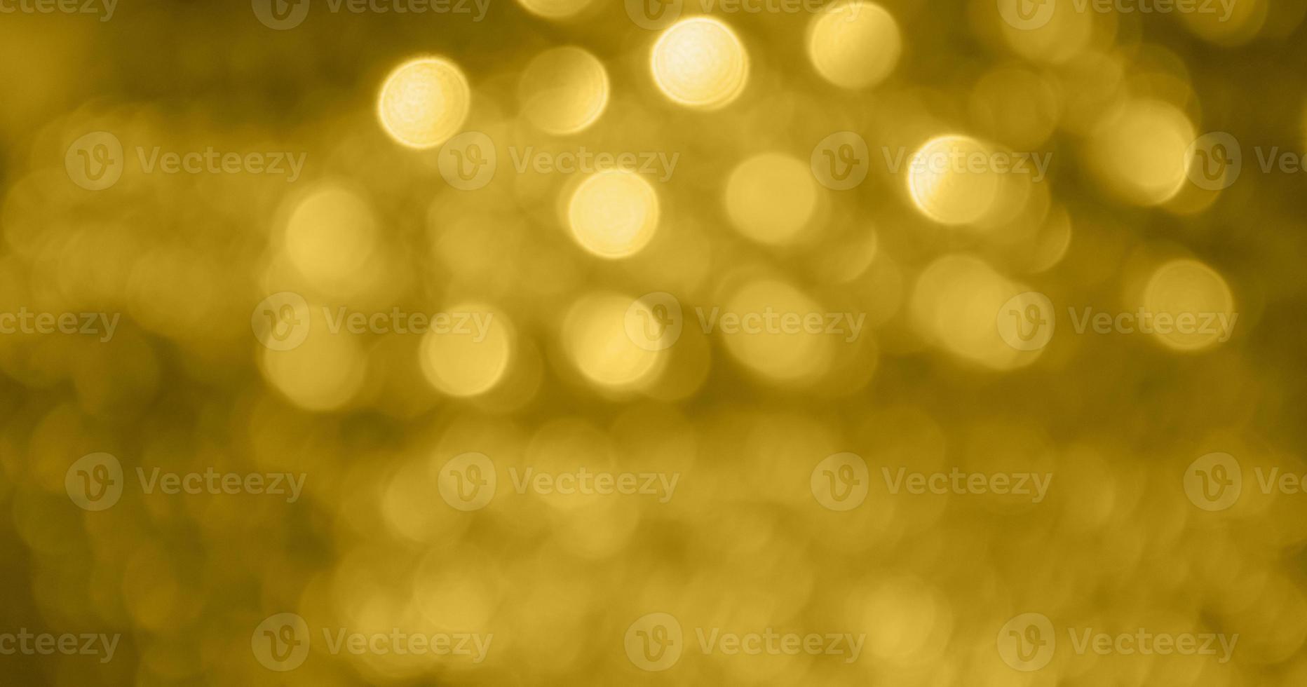 Abstract gold bokeh light festive defocused blur background photo