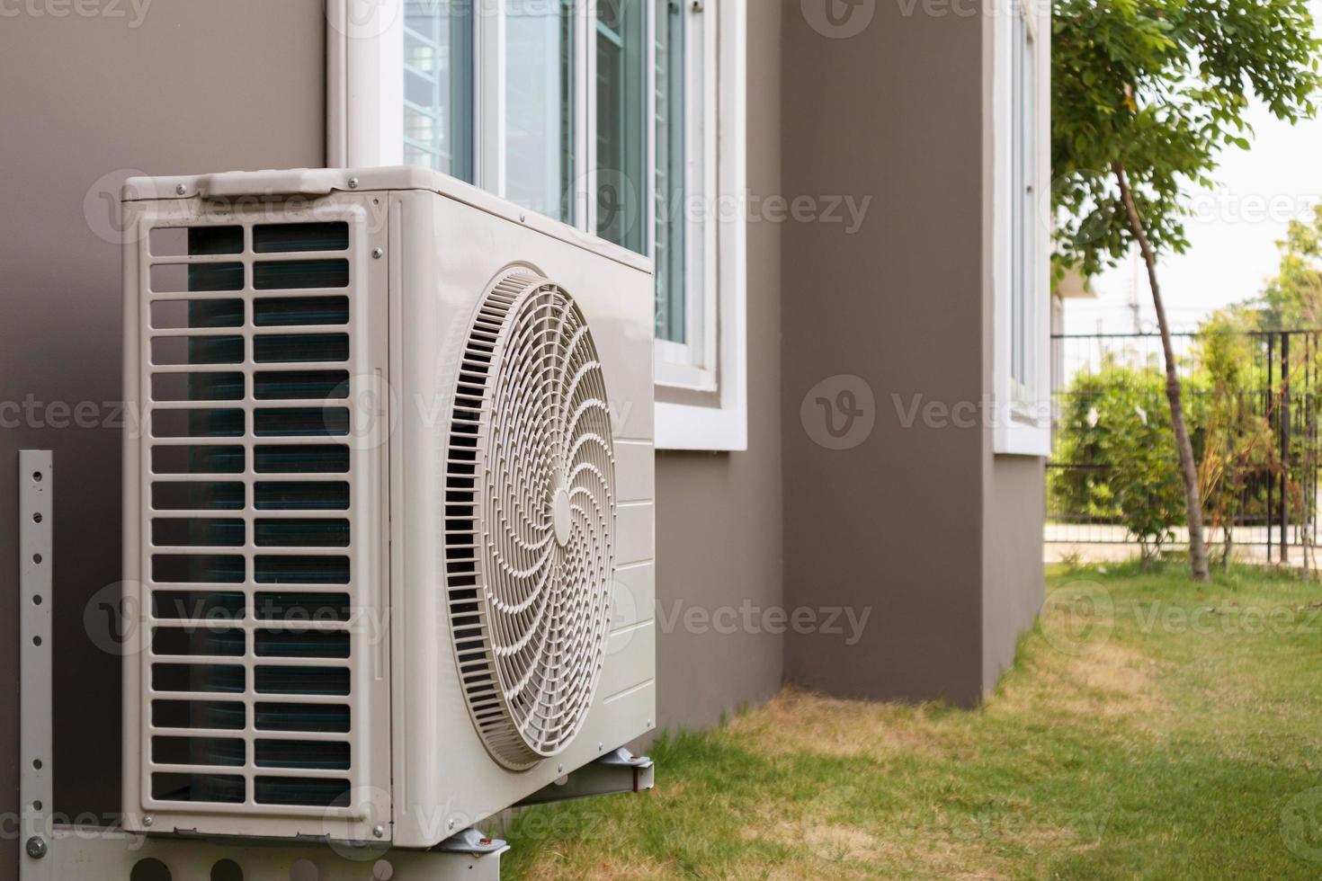 Air conditioner compressor outdoor unit installed outside the house photo