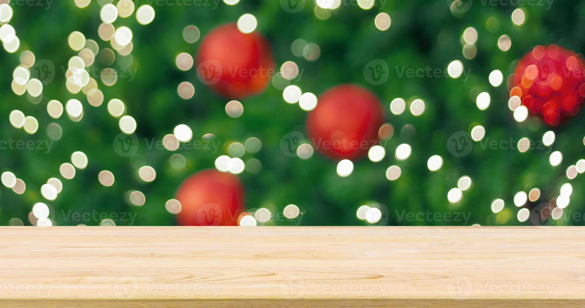 Empty wood table top with Abstract blur Christmas tree with decoration bokeh light background for product display photo