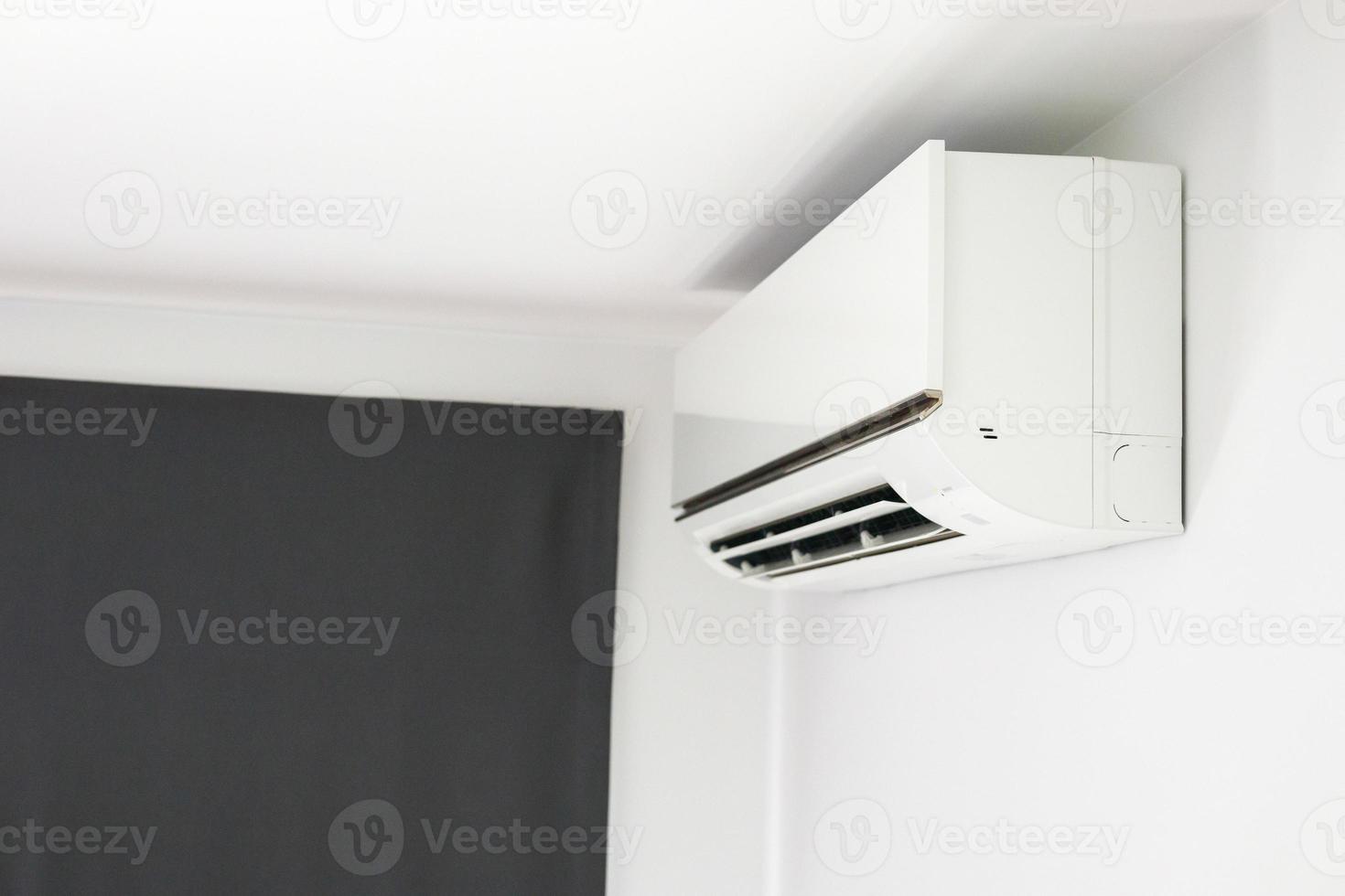 Air conditioner on white wall room interior background photo