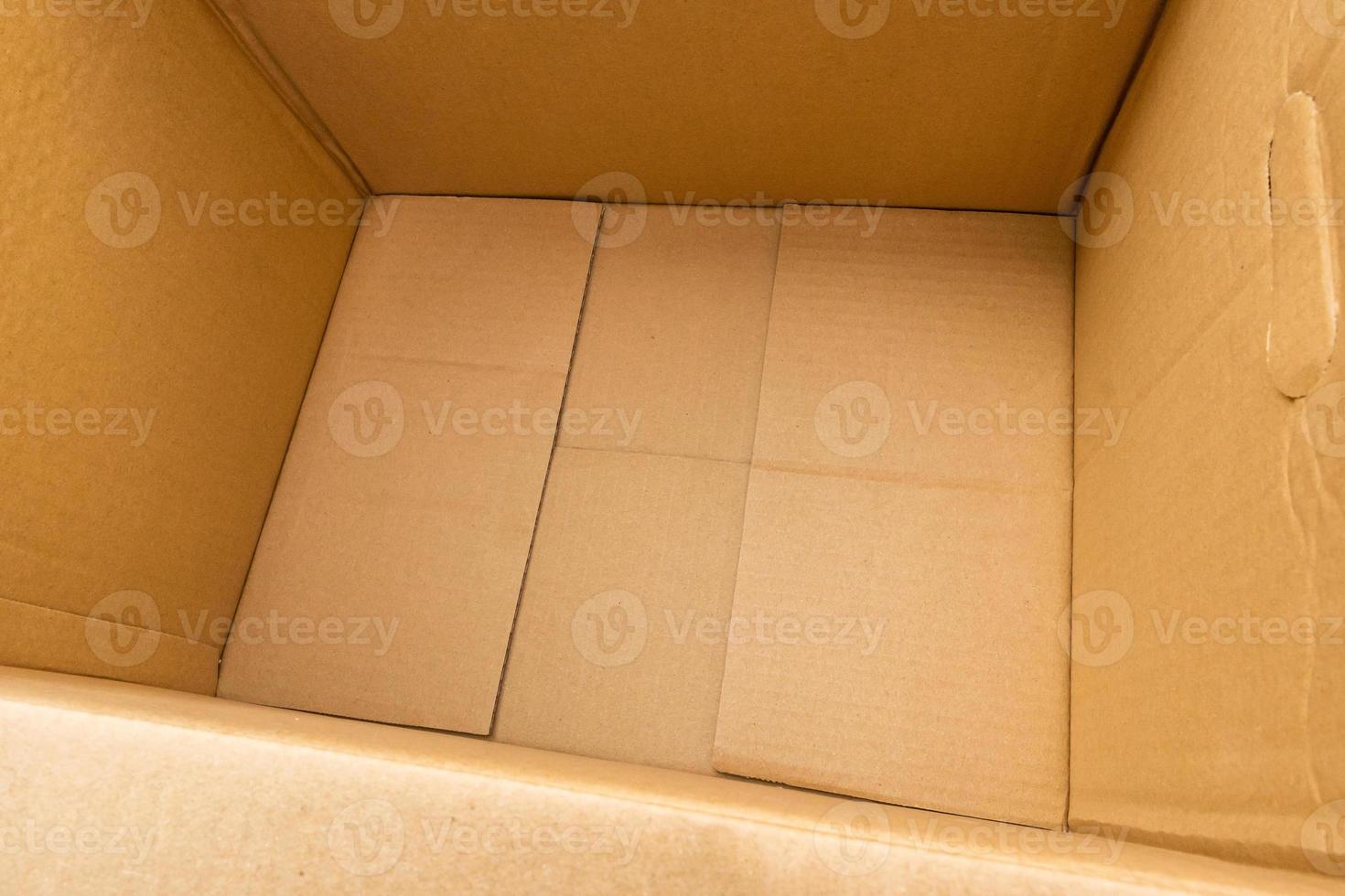 Open empty brown cardboard box background top view photo