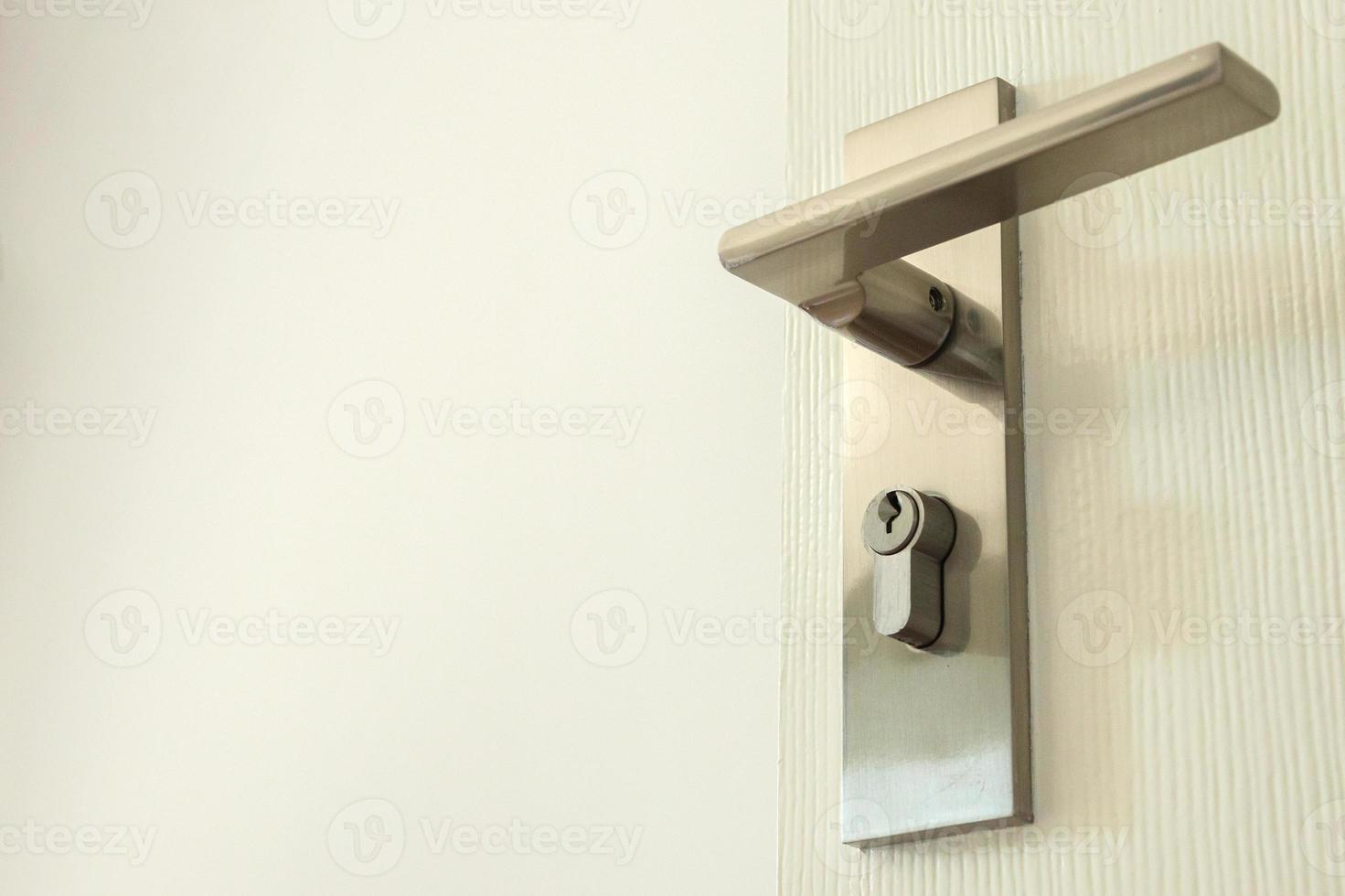 Modern door handle with keyhole on white door 12810810 Stock Photo at