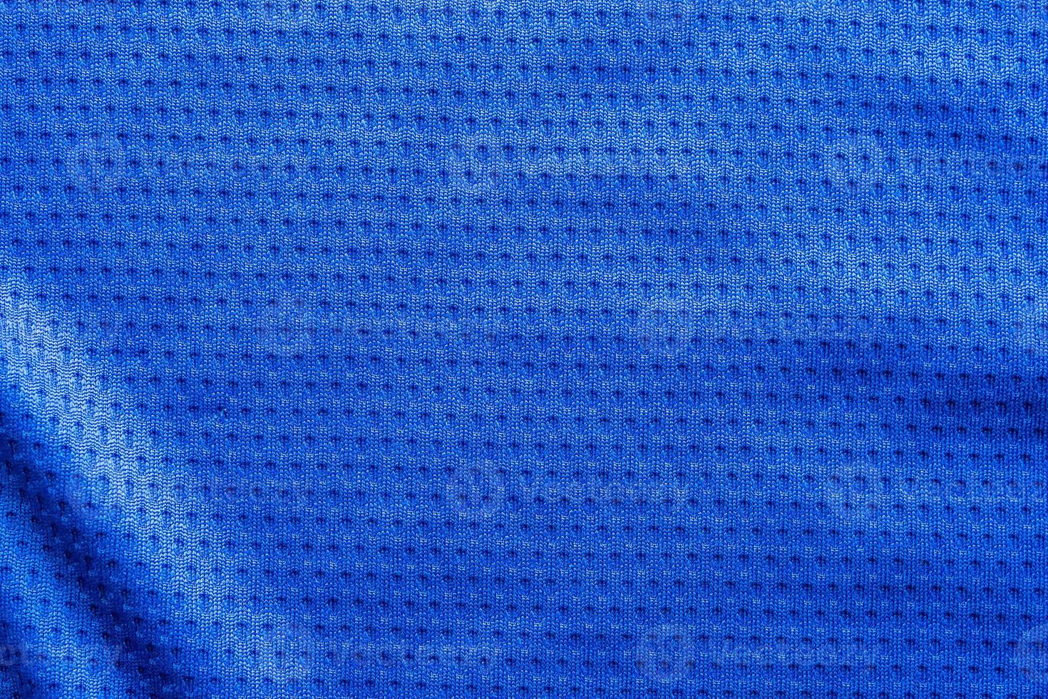 Blue color fabric sport clothing football jersey with air mesh texture background photo