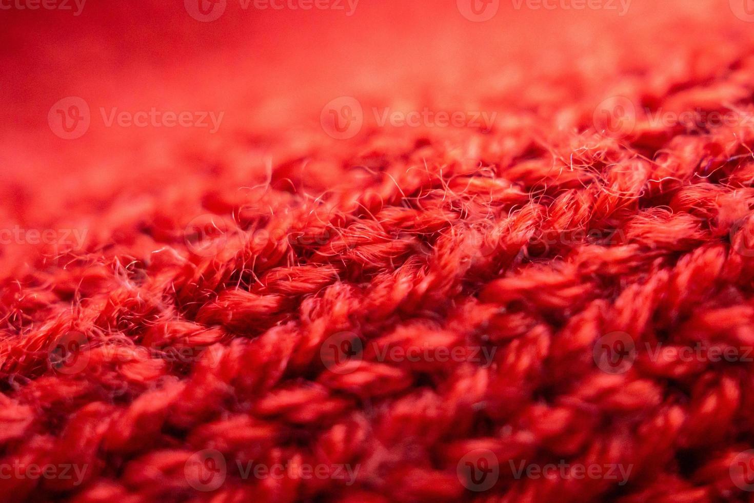 closeup red knitted woolen fabric texture background photo