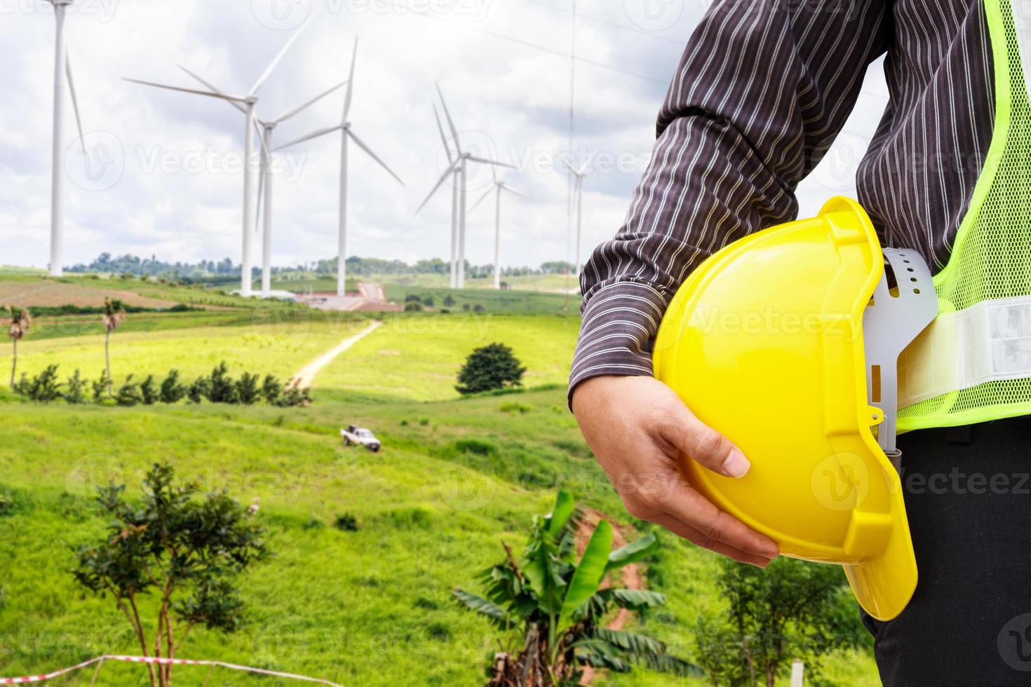 Engineer worker at wind turbine power station construction site photo