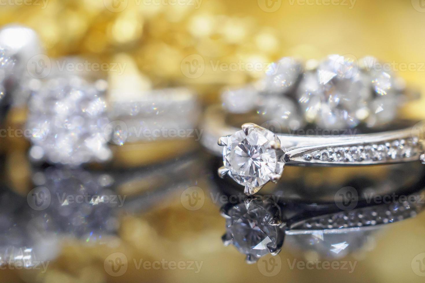 Luxury gold Jewelry diamond rings with reflection on black background photo