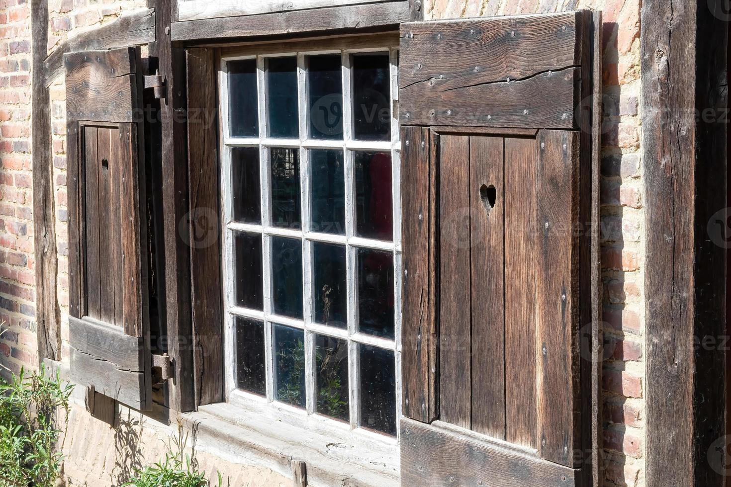 window with shutters on the wall photo