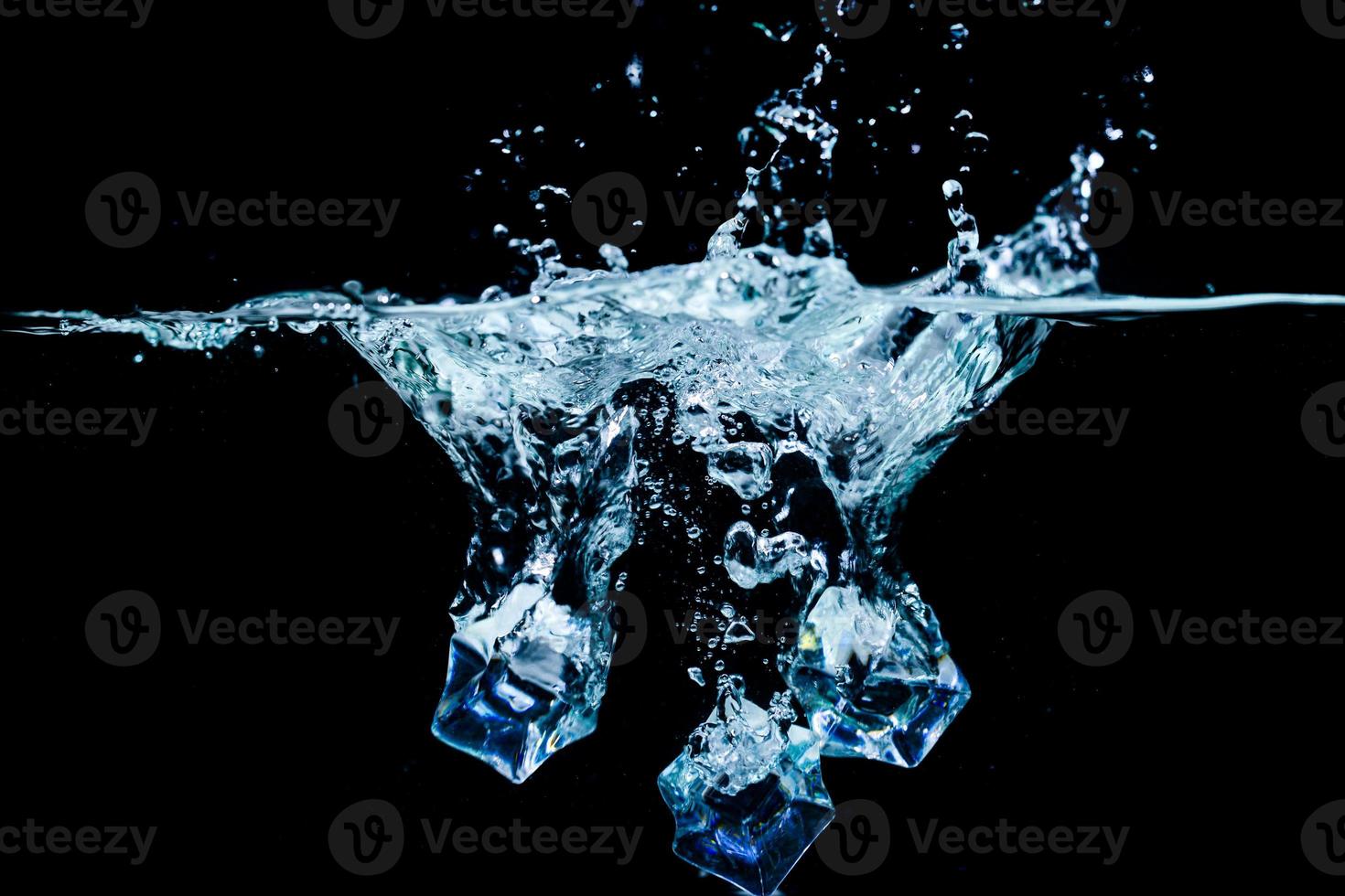 ice cubes in water with bubbles on black background photo