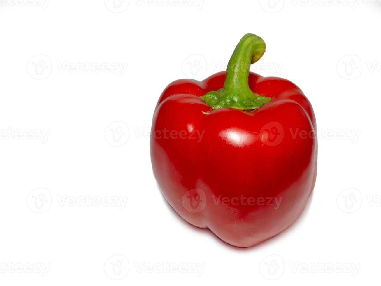 Red bell pepper on a white background. A healthy vegetable in droplets of water. Farm harvest photo
