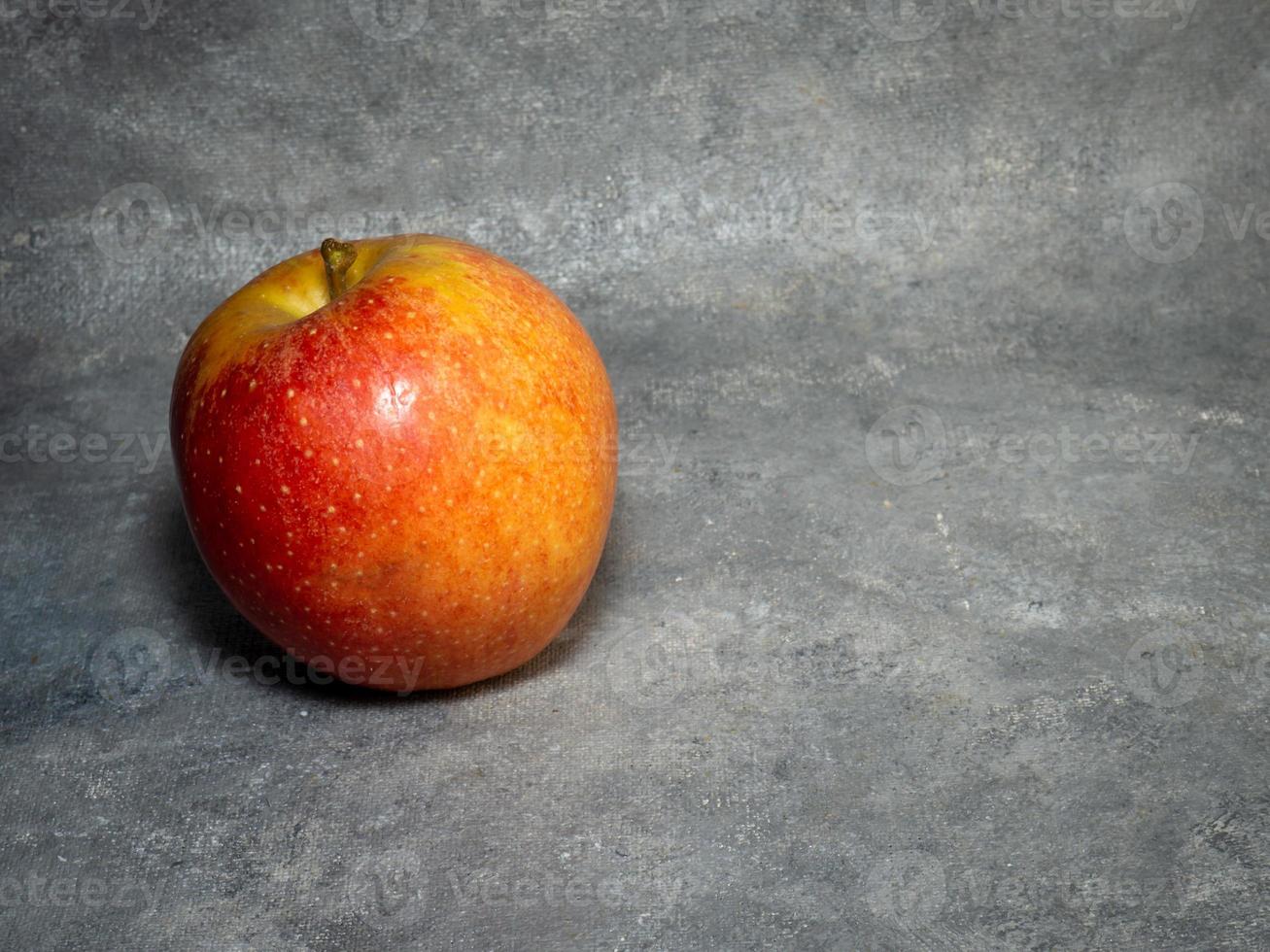 Large red apple on a black background. Gala apple.   Big ripe delicious fruit on the table photo