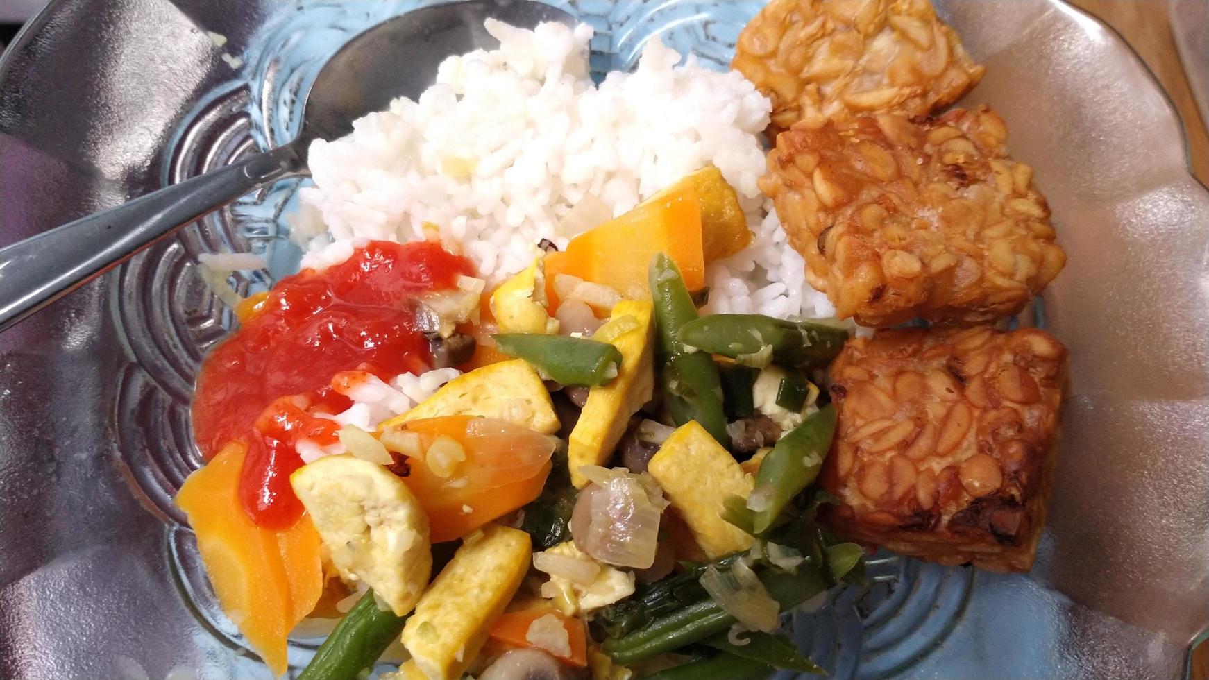 delicious rice with various dishes and chili sambal photo