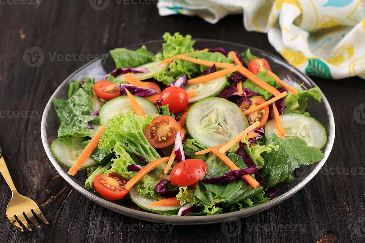 Fresh Salad on a Wooden Background Front View, Concept of Healthy Food and Veggie photo