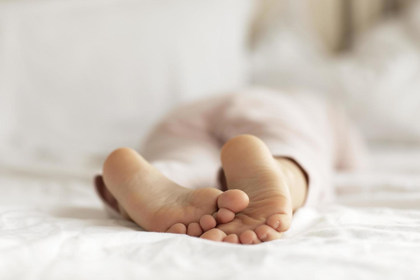 kid sleeping white bed in the morning photo