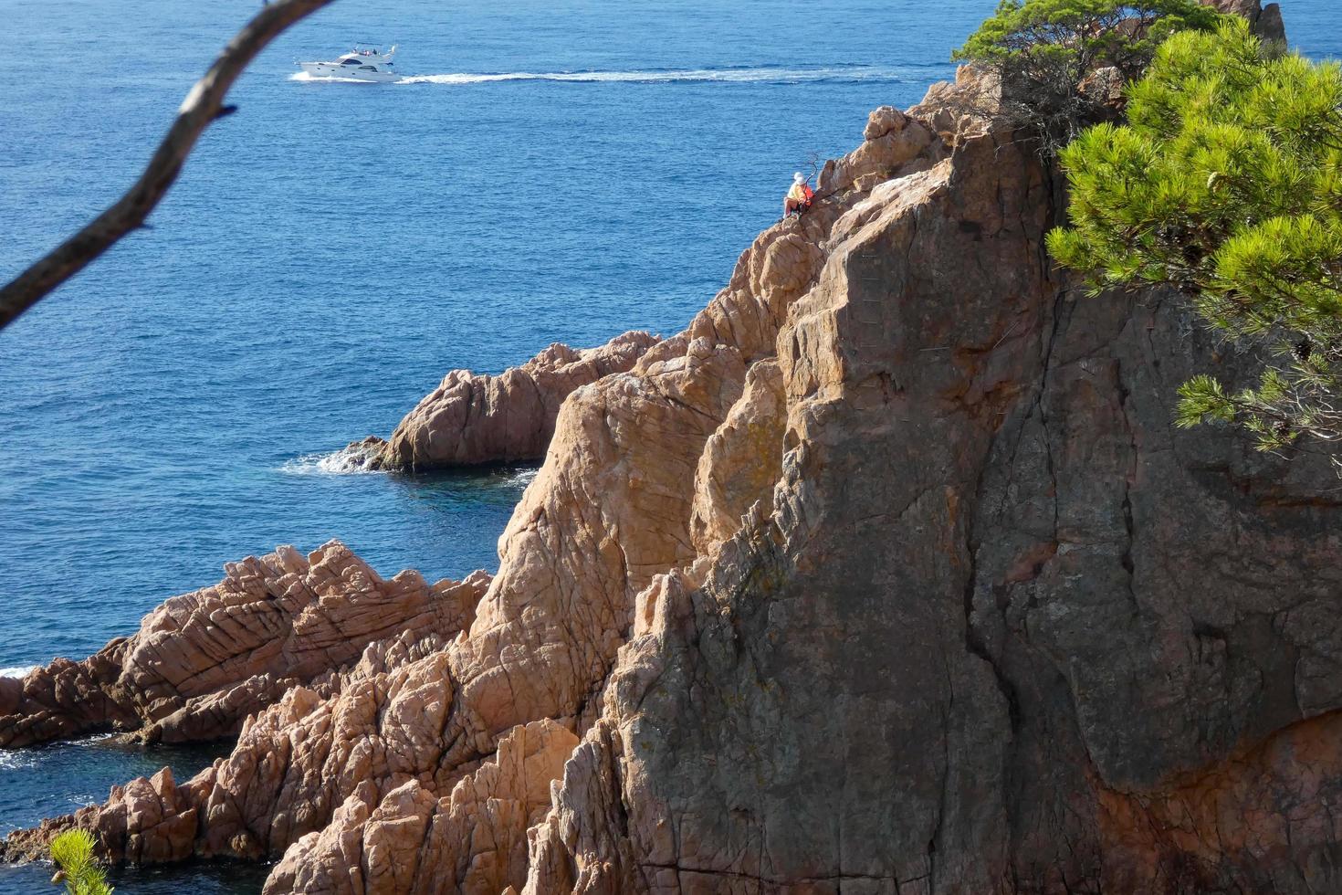 sportsmen doing a via ferrata over the blue mediterranean sea photo
