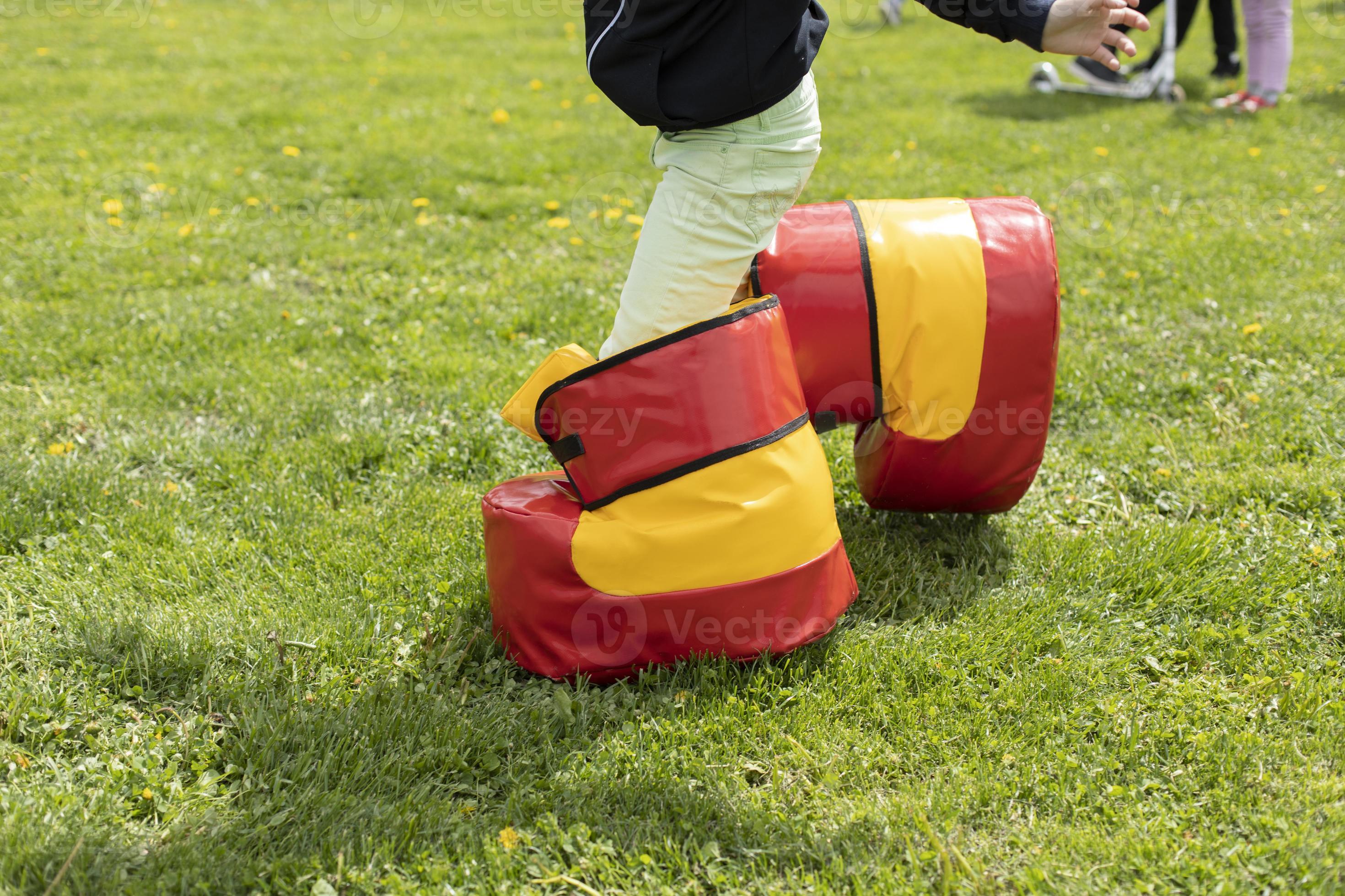 Funny shoes for game. Fun holiday of child in summer. Entertainment on  green grass. 12816903 Stock Photo at Vecteezy