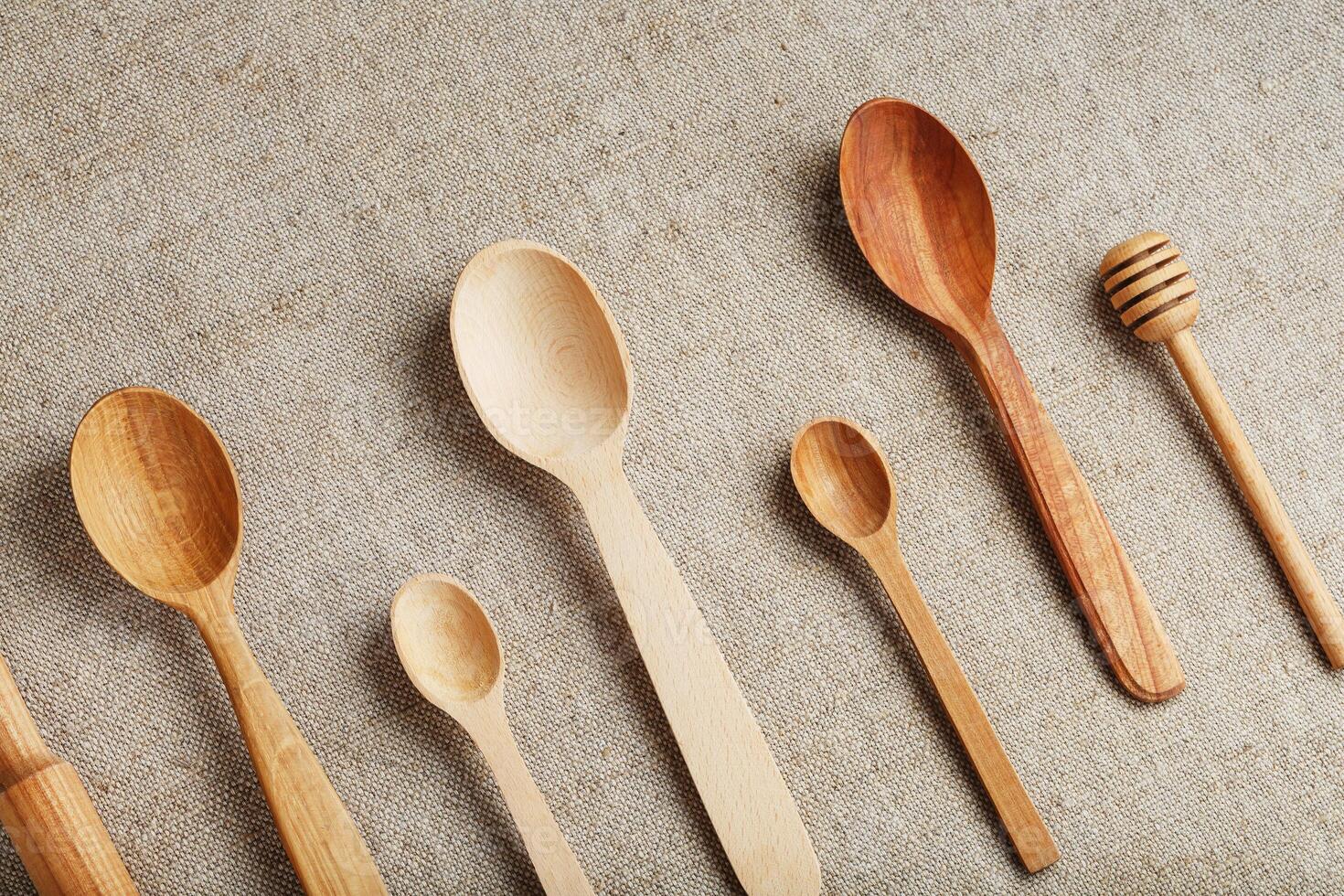Wooden spoons made of natural wood on burlap fabric as a craft