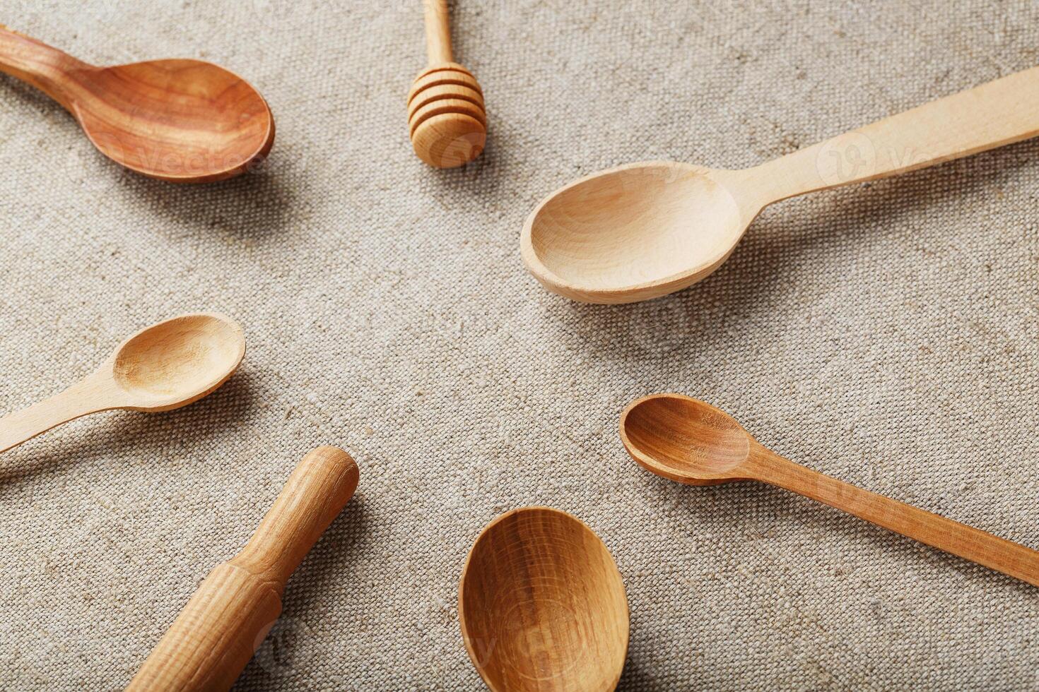 Wooden spoons made of natural wood on burlap fabric as a craft