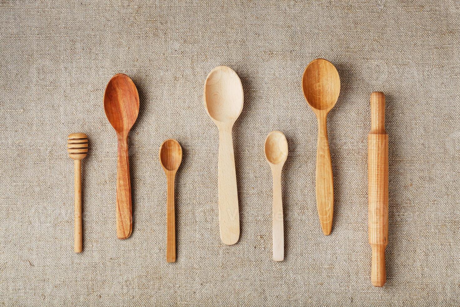 Wooden spoons made of natural wood on burlap fabric as a craft