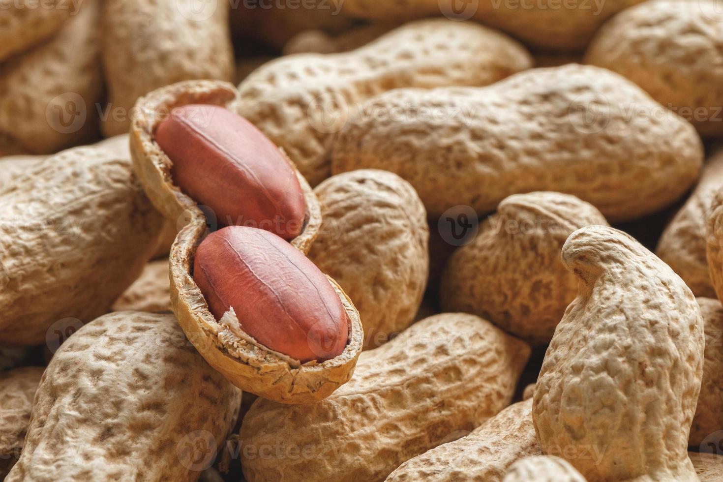 Peeled peanut on well peanuts. Peanuts, for background or textures. photo