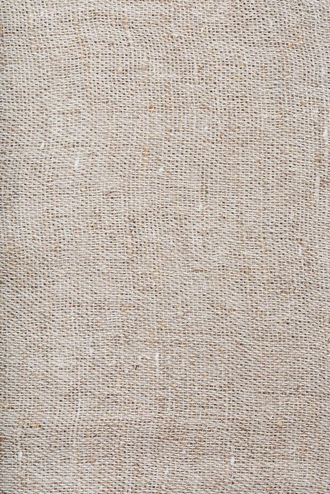 Textured background of fabric from burlap fibers with fibers in full screen photo