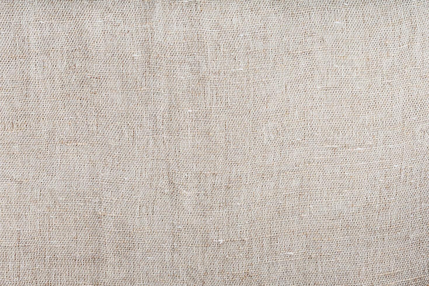 Textured background of fabric from burlap fibers with fibers in full screen photo