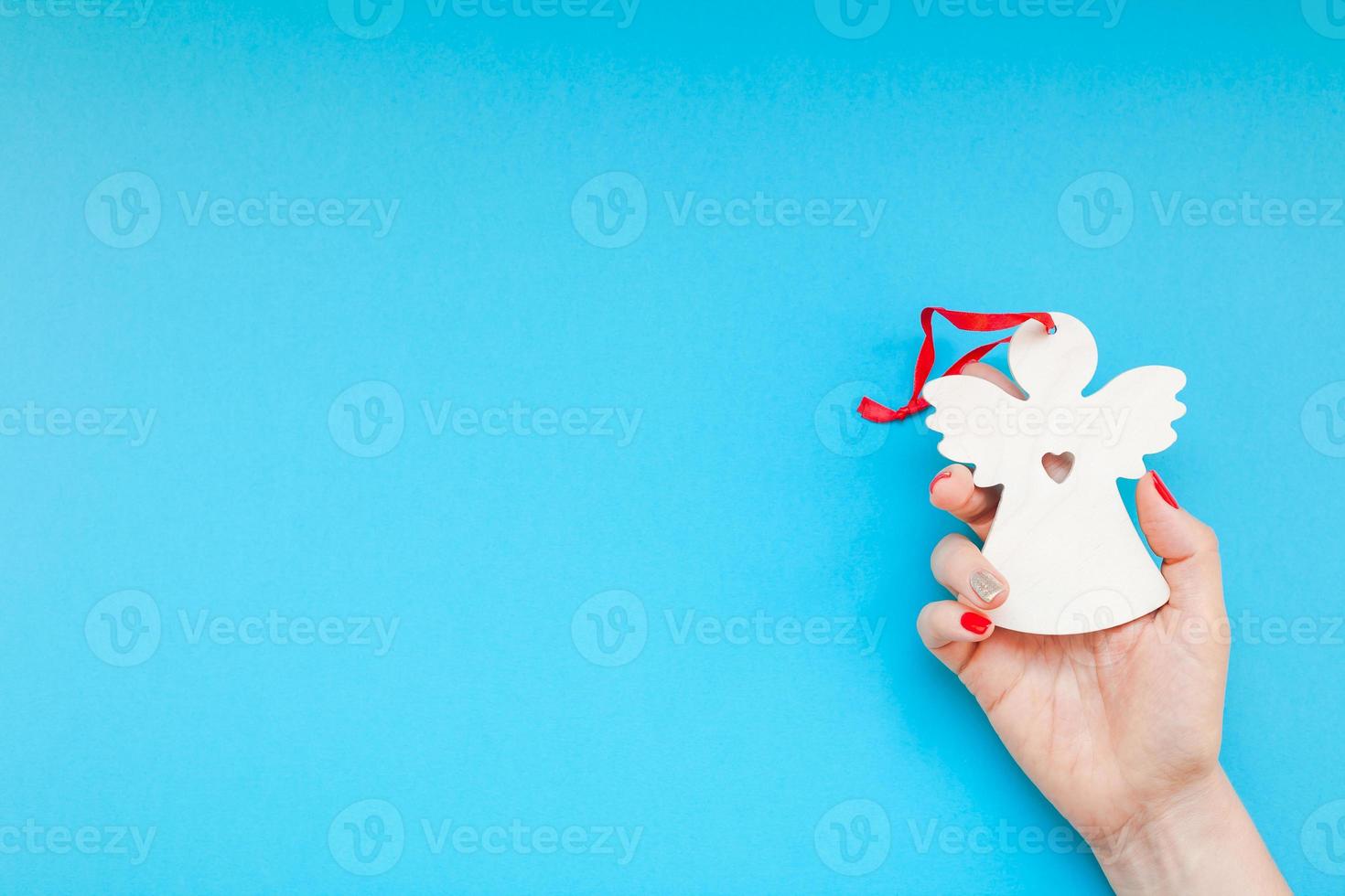 Woman hand holding homemade wooden christmas toy photo