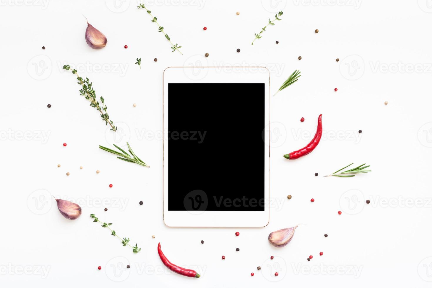 Empty tablet PC with greens herbs and spices photo
