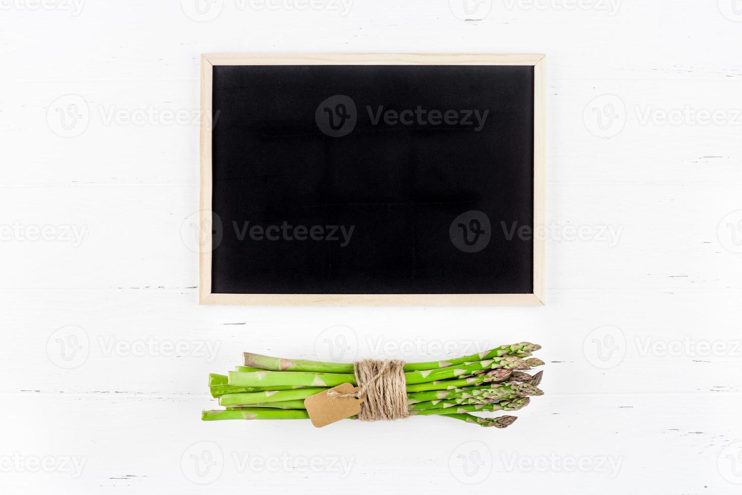 Fresh green asparagus with black chalkboard frame photo