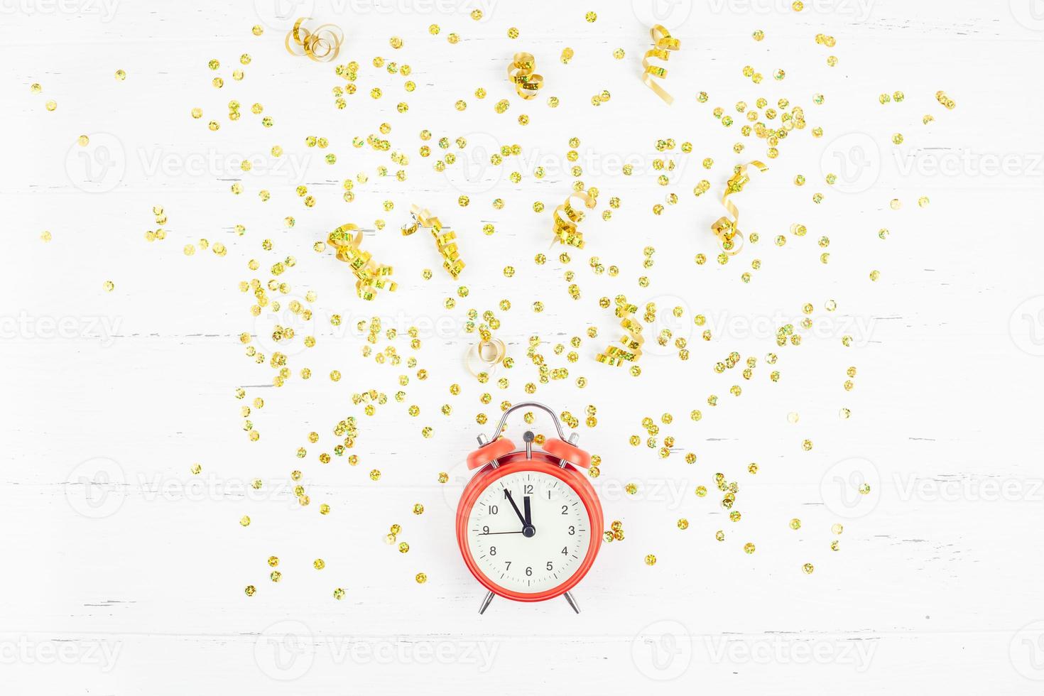 New Year composition alarm clock golden confetti photo