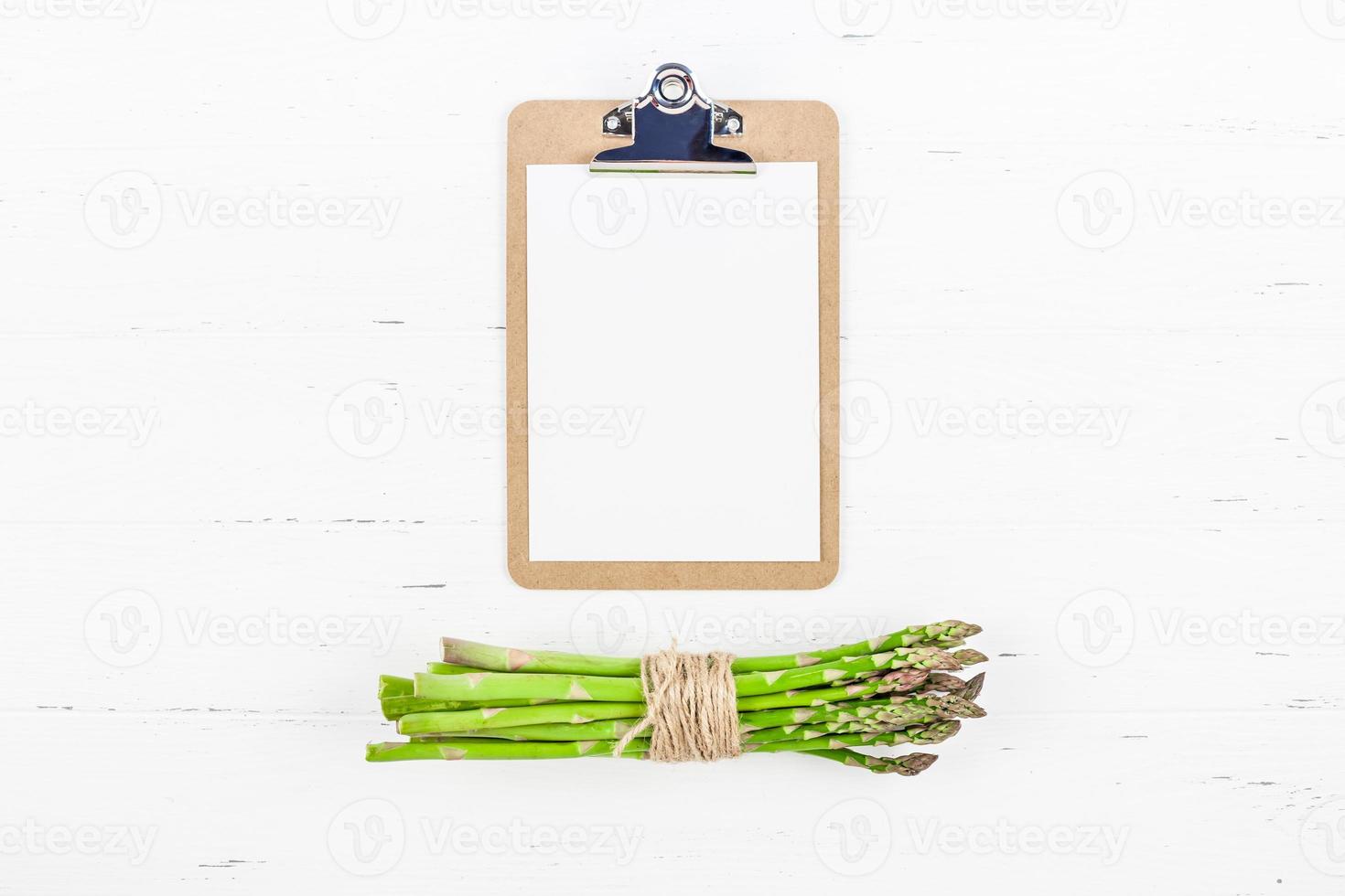 Fresh green asparagus with paper clipboard mockup photo