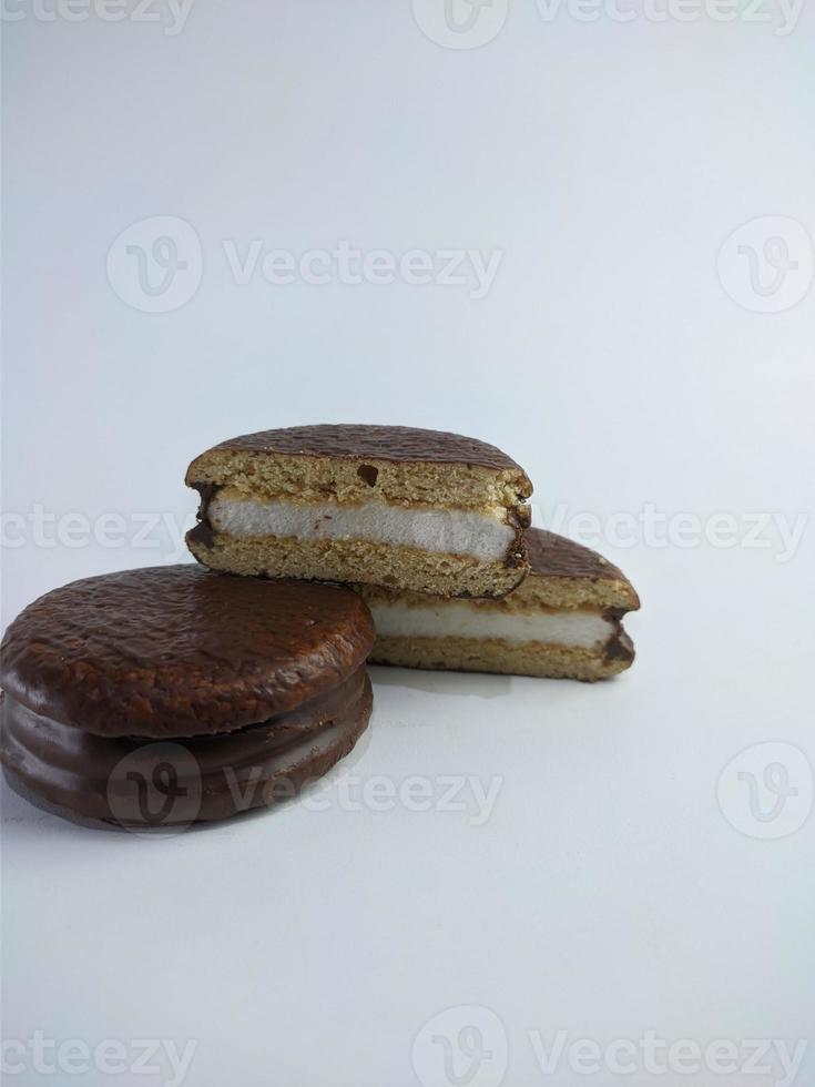 Delicious choco pies with marshmallow on white background. Classic snack cakes photo