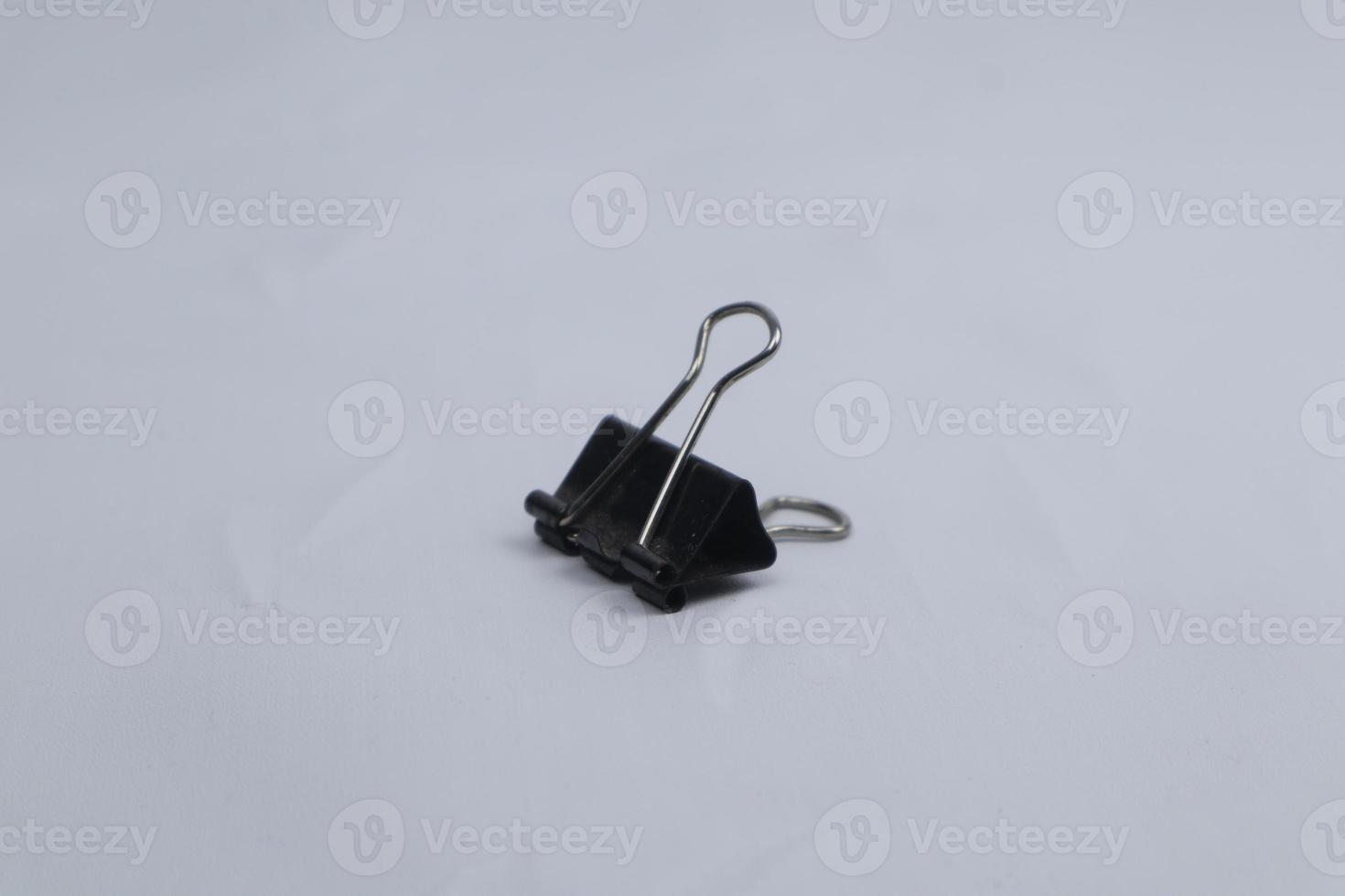 black paper clip isolated on white photo