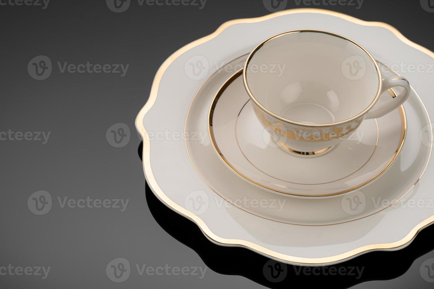 A luxury tableware set on black reflective surface photo