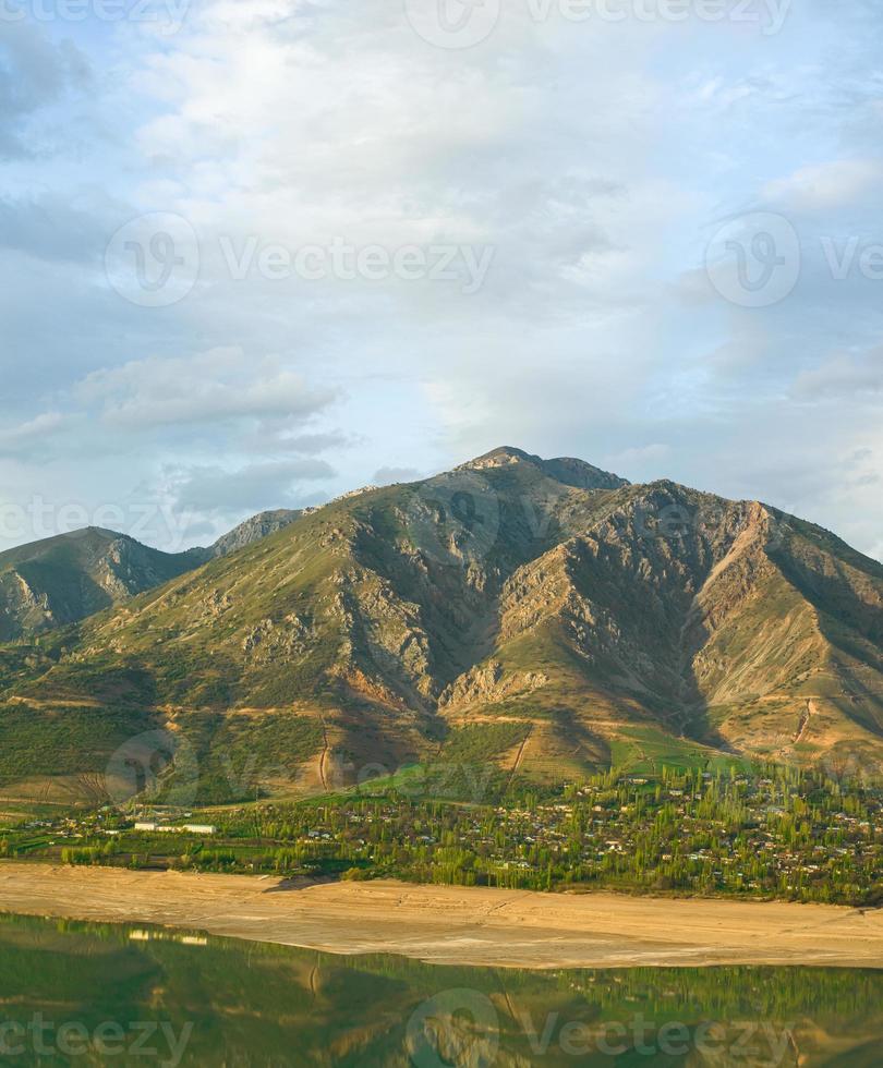 A vertical shot of mountains against the background of the cloudy sky. Central Asia photo