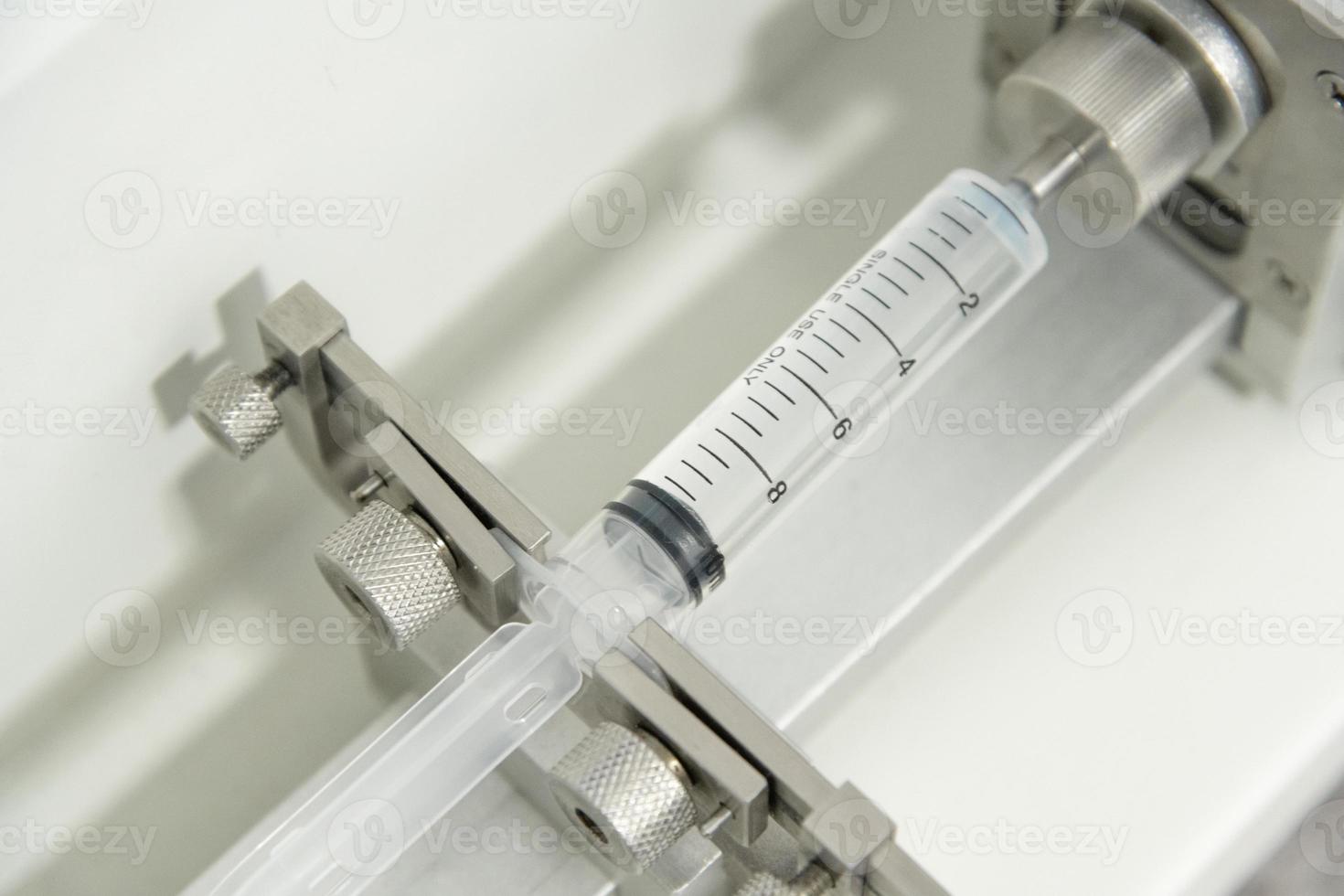 A closeup of the production and testing of medical syringes and droppers photo